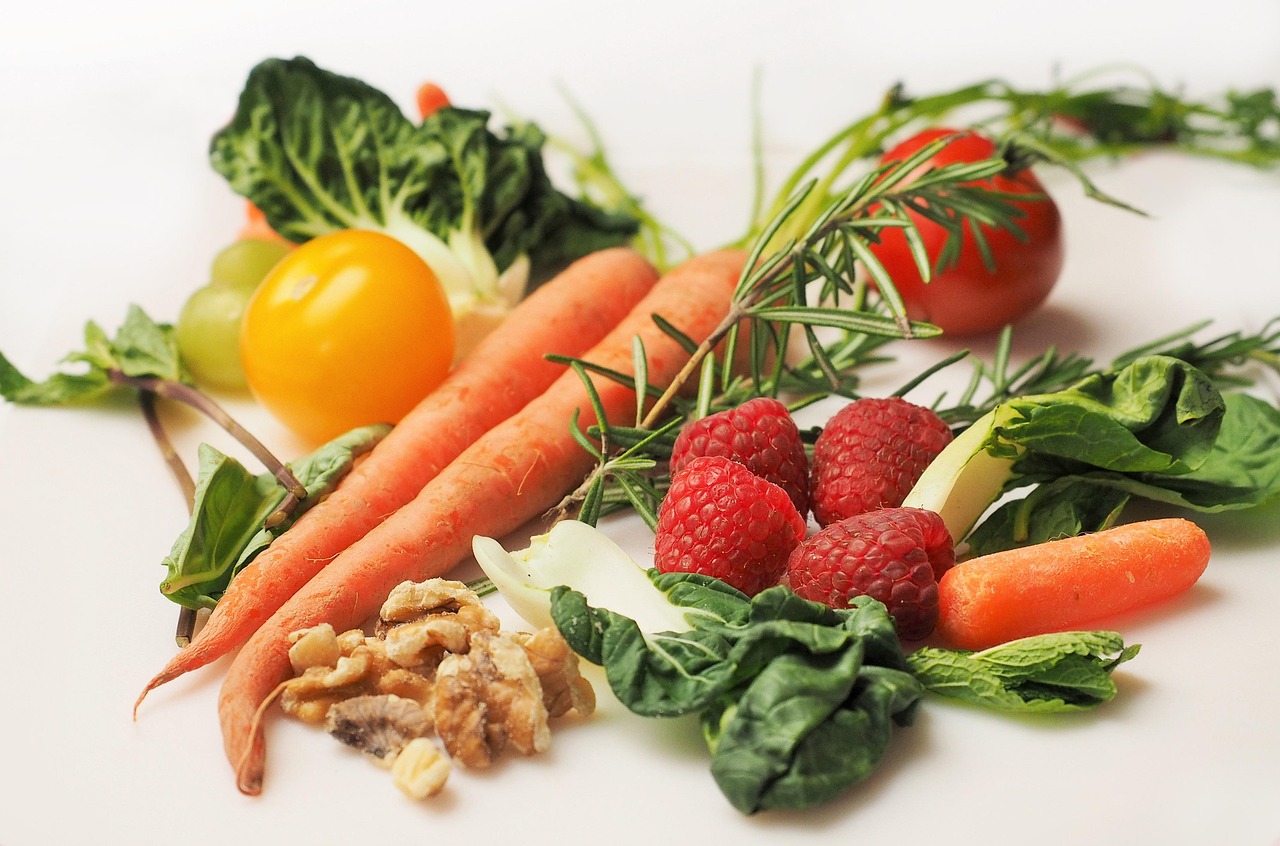 Colorful fresh vegetables arranged on a wooden surface