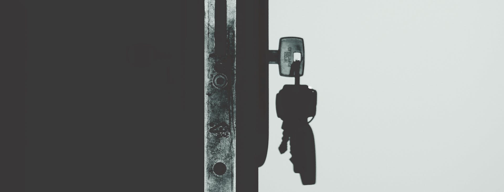 Old metal key resting on a wooden surface