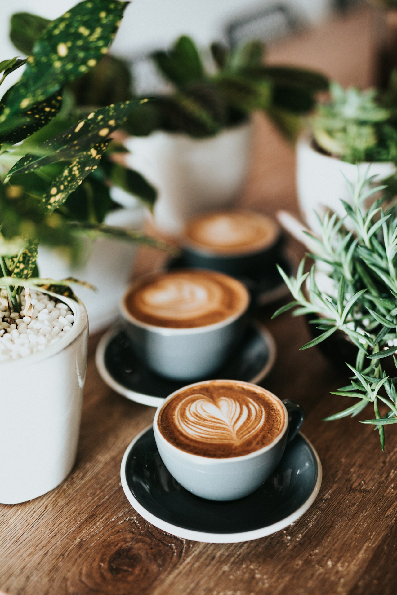 Steaming coffee cup with latte art on a wooden table