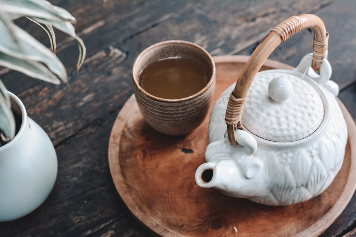 Steaming cup of ginger tea with lemon