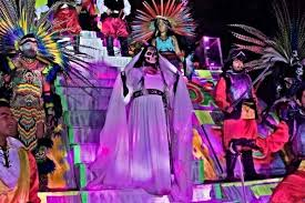 Performers in white robes singing on a floating stage with purple light